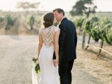 a romantic lace sheath wedding dress with cap sleeves and an illusion back with sheer lace looks very romantic