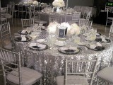 large silver sequin tablecloths and white floral centerpieces will create a cool frozen winter ambience
