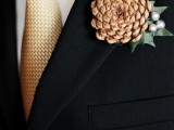 a cute pinecone, greenery and silver berries boutonniere is a lovely piece for a winter groom and groomsmen