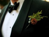 a pinecone, greenery and berries wedding boutonniere is a lovely accessory for a groom or groomsmen in winter