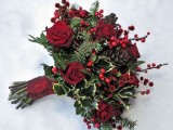 a bold winter wedding bouquet of burgundy blooms, berries, foliage and evergreens is a bold and lovely option