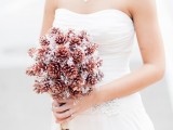 a pinecone wedding bouquet with silver touches is a cool idea of a non-traditional arrangement to rock