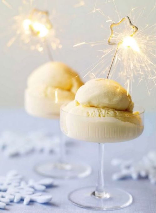 ice cream and sorbet in glasses topped with star-shaped sparklers look very festive and glam-like
