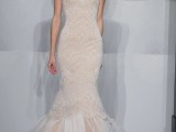 a white and peachy mermaid wedding dress with a strapless neckline and embellishments and a long train is a sexy idea