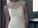 a white sheath wedding dress with an illusion neckline, cap sleeves and embellishments on the bodice