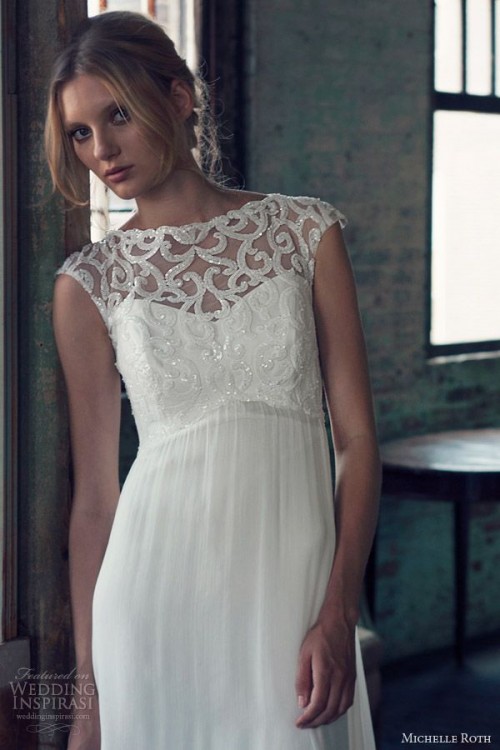 a white sheath wedding dress with an illusion neckline, cap sleeves and embellishments on the bodice
