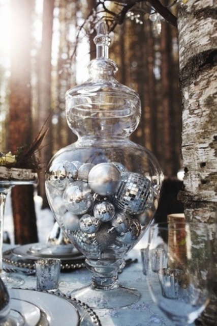 a large jar with a lid filled with silver ornaments is a lovely idea for Christmas and winter holiday weddings