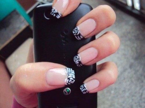 a new take on a French manicure with pink nails and black and white patterns on the tips is a creative and unusual idea