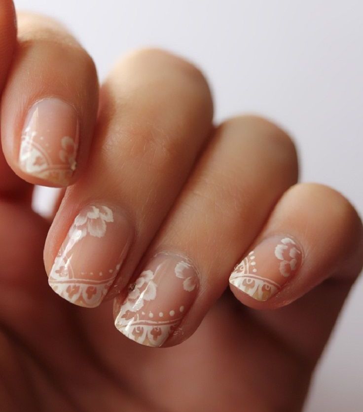 blush nails with very delicate white lace and floral patterns painted on them are amazing for a subtle and tender look