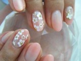 blush nails with white floral appliques and a shamrock are adorable and will easily fit a spring or a summer wedding
