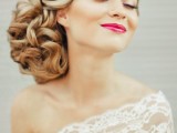 an exquisite wavy low updo with side parting and a rhinestone hairpiece done on long hair is a beautiful idea with a slight vintage feel