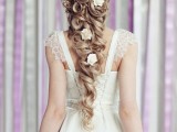 a chic wavy and twisted long ponytail with curls and white blooms is a beautiful and stylish idea for a refined bride, an elegant take on a classic braid