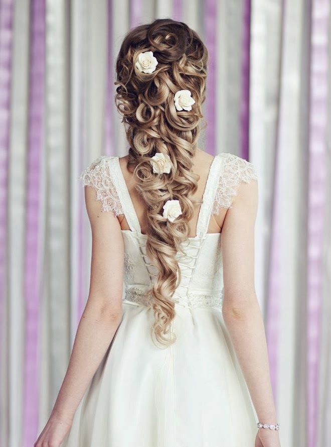 A chic wavy and twisted long ponytail with curls and white blooms is a beautiful and stylish idea for a refined bride, an elegant take on a classic braid