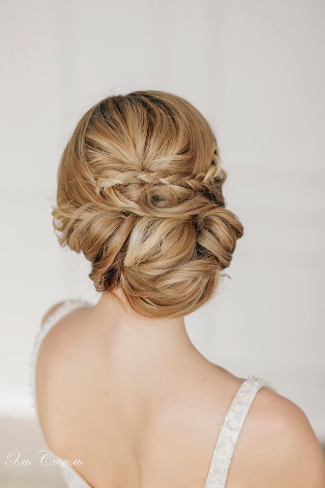 A tight wavy and twisted low chignon with lots of swirls on long hair is a unique way to show off your locks and their length, it doesn't require any additional detailing