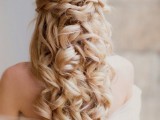 a gorgeous half updo with a volume on top, a braided and twisted halo and waves down is a fantastic idea for a bride with long and thick hair