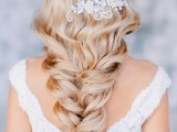 a gorgeous wedding hairstyle – a twisted and wavy long braid accented with a lovely lace and rhinestone hairpiece is amazing
