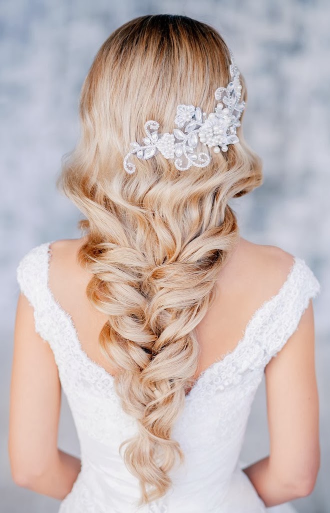 A gorgeous wedding hairstyle   a twisted and wavy long braid accented with a lovely lace and rhinestone hairpiece is amazing