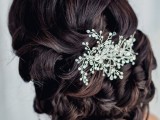 a low updo with waves and twists on top plus a fantastic rhinestone hairpiece is a refined and elegant solution for a vintage-inspired bridal look