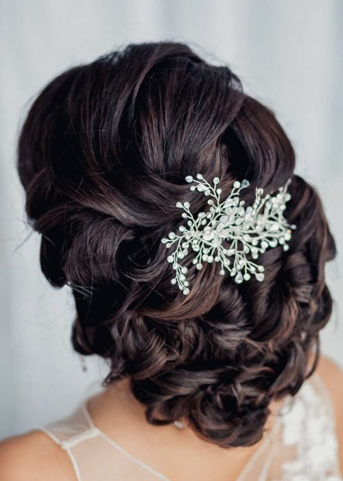 a low updo with waves and twists on top plus a fantastic rhinestone hairpiece is a refined and elegant solution for a vintage-inspired bridal look