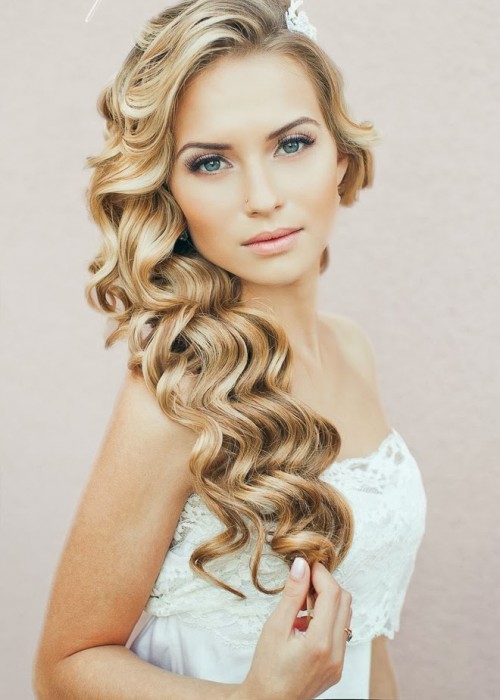 long Hollywood waves down accented with a lace hairpiece is a lovely idea that will match many bridal looks easily