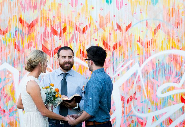 a colorful graffiti inspired wedding backdrop is a fun and cool idea for a modern wedding, and the combo of colors used is striking