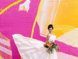 a super bold fuchsia, yellow and light pink graffit wall is a gorgeous backdrop for your modern wedding