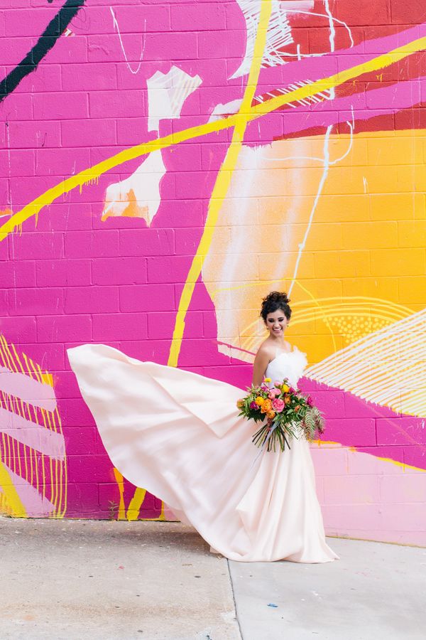 a super bold fuchsia, yellow and light pink graffit wall is a gorgeous backdrop for your modern wedding