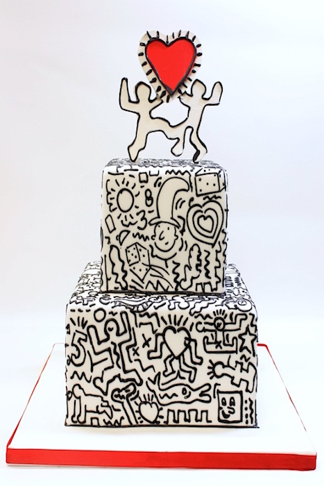 a square white wedding cake with black graffiti, a fun red heart and graffiti topper is a lovely idea for a modern wedding