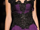 a gorgeous purple wedding dress with shiny black lace and embellishments, catchy shoulders and a neckline