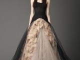 a strapless black and tan wedding ballgown with a sleek bodice and a skirt with tiers of tan tulle