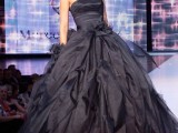 a glossy black strapless wedding ballgown with a tiered skirt and a sleek bodice is a stylish idea for Halloween