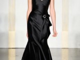 a glossy black strapless mermaid wedding dress with a sash and a buckle is a stylish and refined idea