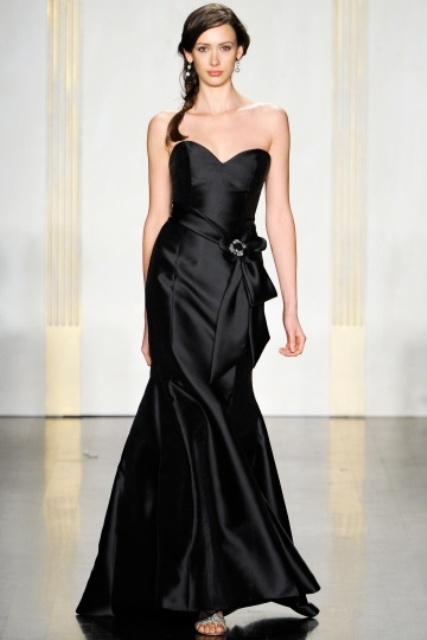 a glossy black strapless mermaid wedding dress with a sash and a buckle is a stylish and refined idea
