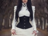 a Victorian white wedding dress with a high neckline and puff sleeves plus a corset looks a bit scary and very stylish