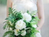 a pretty and classic wedding bouquet of greenery, fern and white blooms will easily fit a woodland wedding, too