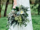 a stylish woodland wedding bouquet of various types of eucalyptus, white blooms and some wildflowers