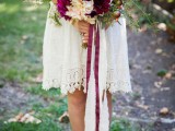 a bright fall wedding bouquet of blush and purple blooms, with apples and berries and greenery will fit a woodland bride, too