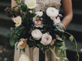 a catchy woodland wedding bouquet of white and blush blooms, lots of privet berries and foliage is a lovely idea for a garden or forest bride