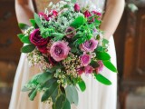 a bold cascading wedding bouquet of pink and fuchsia blooms, white smaller ones and foliage is a stunning idea for a summer bride