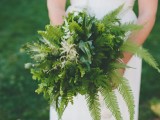 an airy dimensional wedding bouquet of various types of greenery, pink blooms and herbs for a spring or summer forest bride