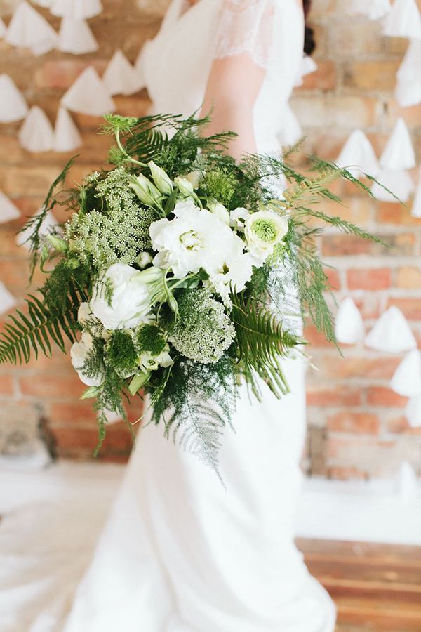 A beautiful wedding bouquet of white blooms and various kinds of greenery and ferns is great for a spring or summer bride