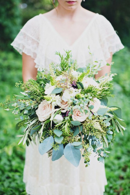 a large woodland wedding bouquet of blush blooms and various types of greenery is a pretty idea for spring or summer