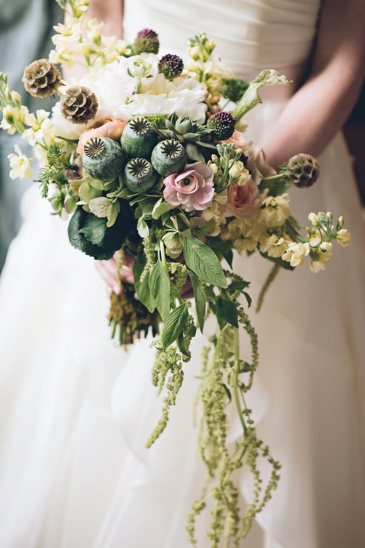 A cascading wedding bouquet of greenery, white and pink blooms, dried blooms and succulents is a catchy idea