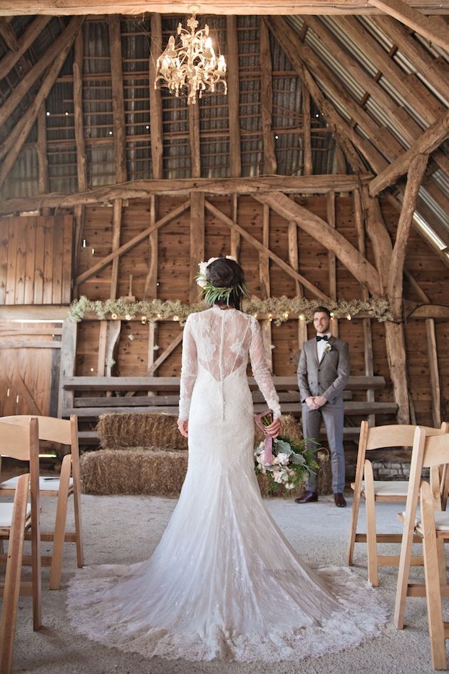 A romantic lace fitting wedding dress with long sleeves, an illusion back and a train