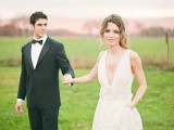 a chic modern wedding gown with a plunging neckline, thick straps, an embellished sash and a plain skirt