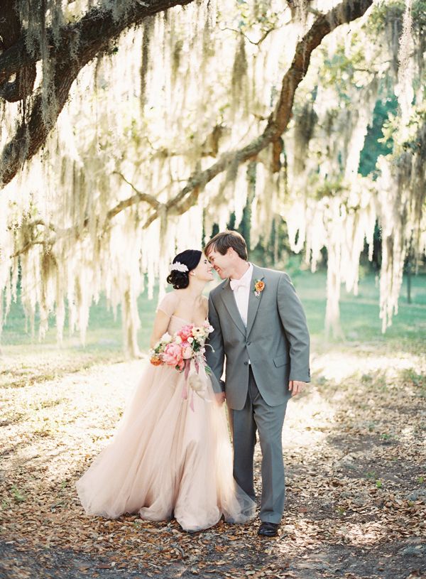 A blush A line wedding dress with cap sleeves and a square cutout is a very romantic outfit idea for a barn bride