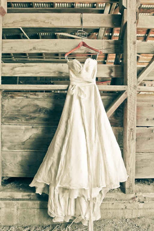 A textural strapless wedding dress with a draped bodice, a sash with a bow and a train