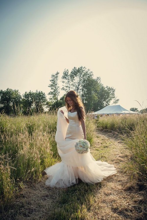 a strapless mermaid wedding dress with a train for a modern barn wedding outfit