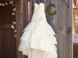 a princess wedding gown with a strapless neckline,  a draped bodice and skirt and a train for a barn princess