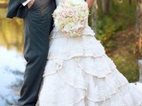 a vintage-inspired strapless wedding dress with a ruffle skirt and a long train, a silk sash and a lace bodice